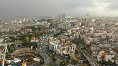 Wide aerial view of highway traffic in Istanbul Turkey next to old European residential buildings at
