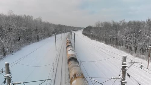 Freight Train Moving Through Snowy Winter Landscape