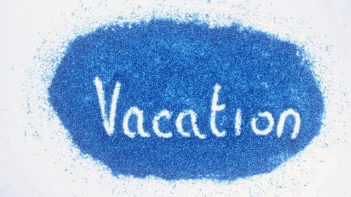 Writing Vacation Message on Pile of Blue Powder