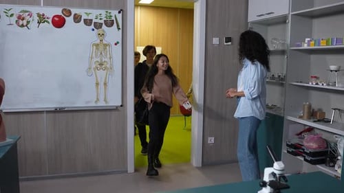 Students Arriving in Classroom, Greeting the Teacher