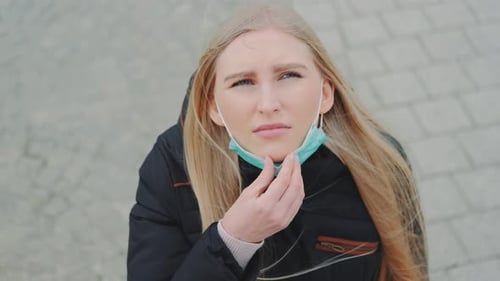 Woman Wearing Surgical Mask Outdoors on City Street