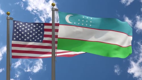 Flags of USA and Uzbekistan Waving Together on Flagpoles