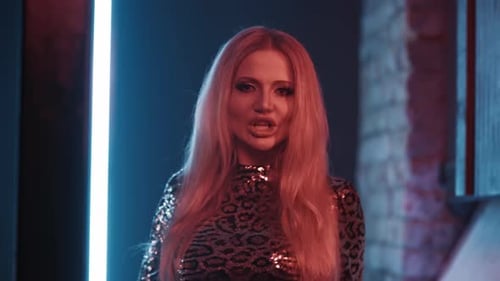 Woman Singer with Bright Makeup Sings a Song in the Studio for a Music Video