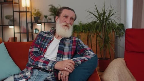 Senior Man Relaxing on Couch Indoors