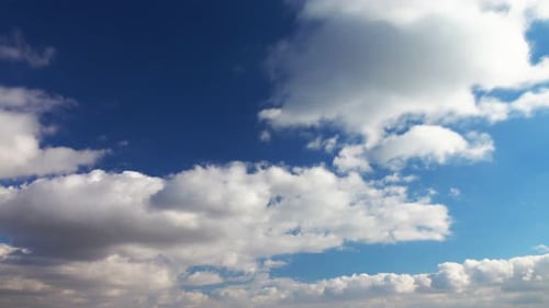 Billowing White Clouds Against Deep Blue Sky