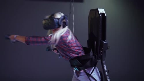 Woman Plays Immersive Virtual Reality Game with Headset