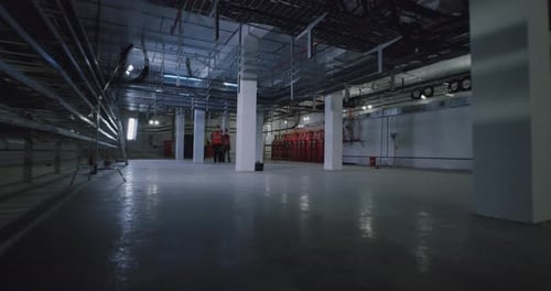 Anonymous Employees Working in Spacious Workshop
