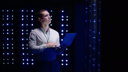 Young Adult Working in Dark Data Center