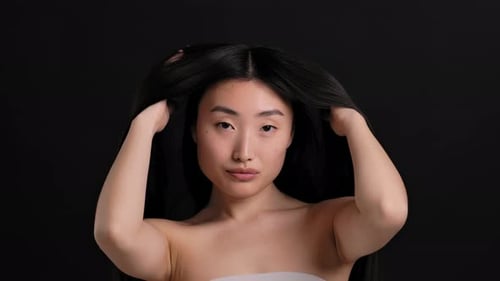 Woman Styling Her Long Black Hair