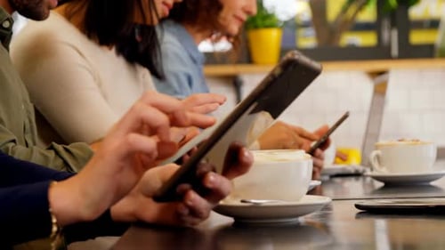 Mid section of executives using digital tablet at table 4k