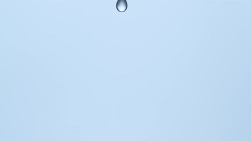 Water Droplet Creates Ripples on Water Surface