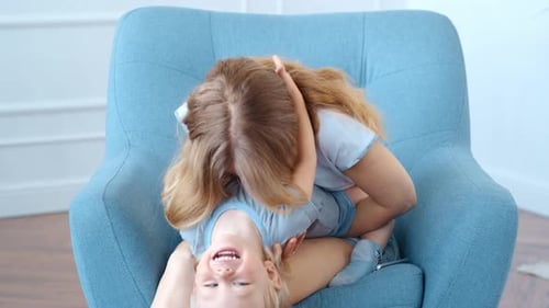 Loving Mother and Child Cuddle in Armchair