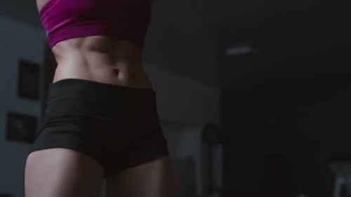 Woman Doing Squats at the Gym