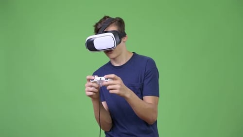 Teen Playing Video Game Using VR Headset