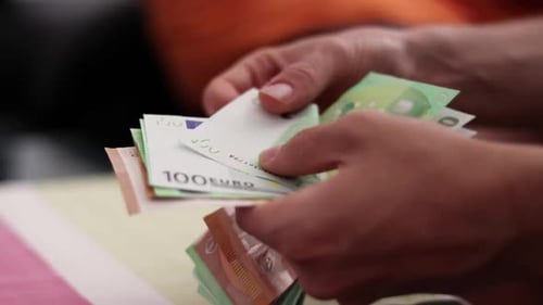 Male hands counting euro bills of 100 and 50