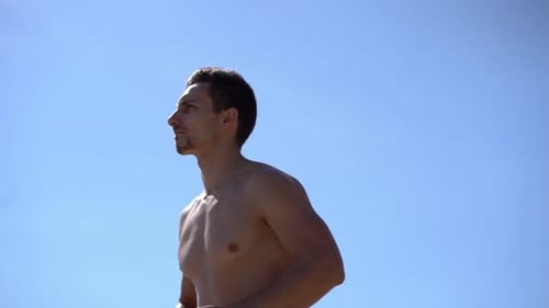 Shirtless Man Running Outdoors on Sunny Day