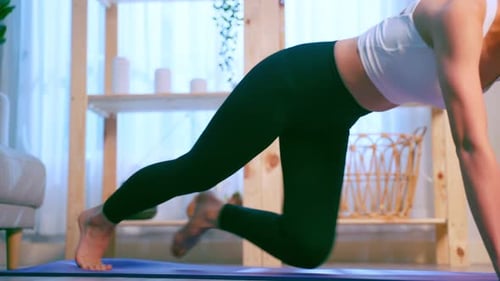 Young Woman Does Mountain Climber Exercise at Home