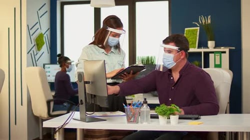 Office Workers Wearing Masks and Face Shields