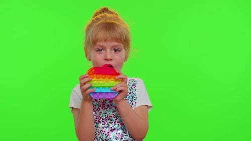 Stylish Child Girl Playing Colorful Squishy Silicone Bubbles Sensory Pop It Toy Game on Chroma Key