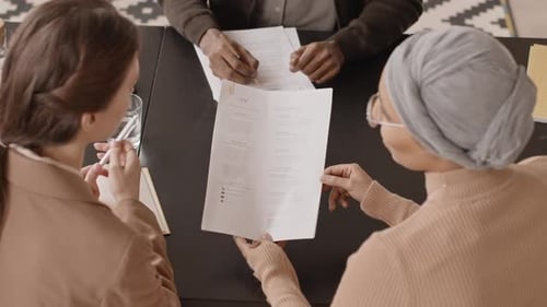 Team of HR Managers Reading Candidate CV