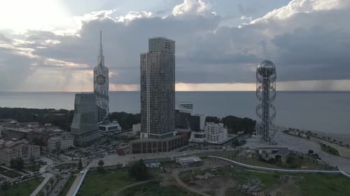 Aerial shot of alphabetic tower, skyscrapers and embankment of beautiful city of Batumi, Georgia