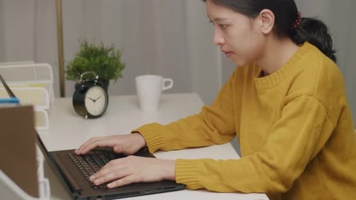 Business caucasian female working on a laptop in her home office.