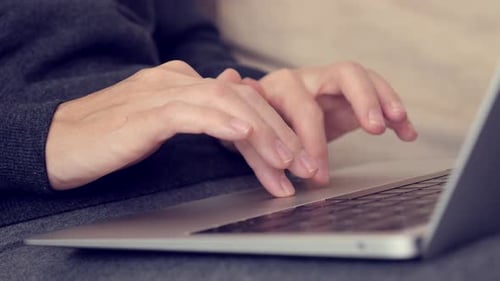 Hands Typing on Laptop Keyboard Trackpad
