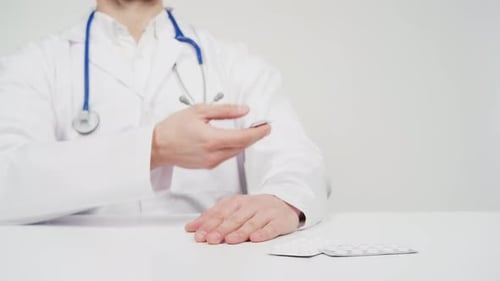 Doctor giving a pills to a patient