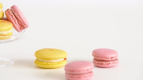 Yellow and Pink Macarons on Glass Stand and Table