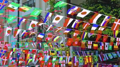 Rows of Colorful International Flags Flying in City