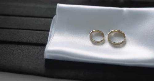 Wedding Rings on White Satin Cushion Close Up