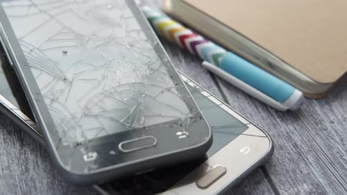 Close Up of Broken Smart Phone on Wooden Background