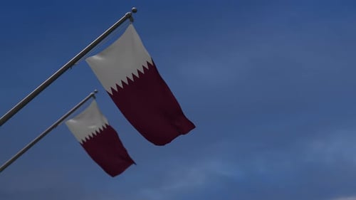 Realistic Qatar National Flag Waving Against Blue Sky