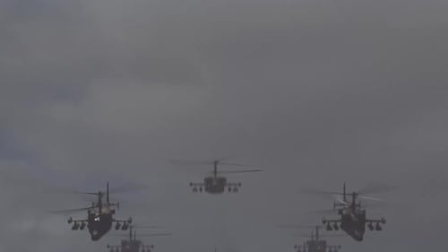 A large number of military helicopters flying in the dirty sky. the concept of war, military conflic