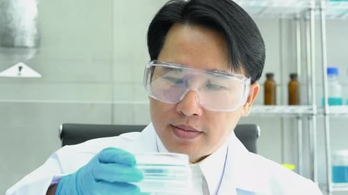 Scientist experimenting chemicals in science laboratory