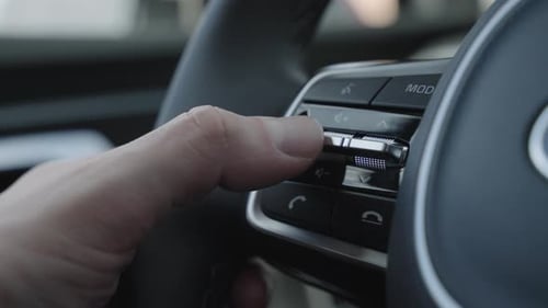 Close Up of Finger Pressing the Audio Control Buttons to Increase or Decrease the Volume