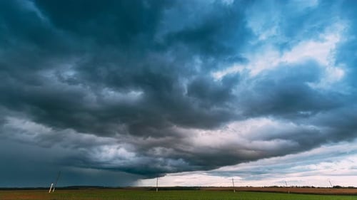 Dramatic Sky Before Rain With Rain Clouds On Horizon Above Rural Landscape Field Meadow