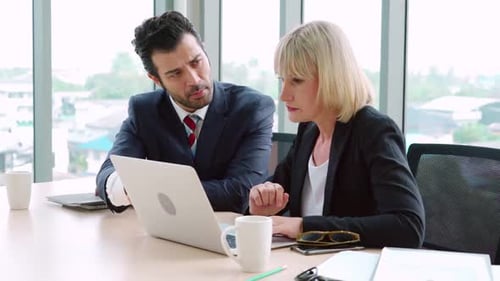 Two Business People Talk Project Strategy at Office