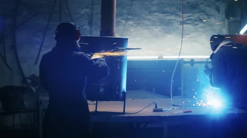 Assembling Metal Structures Making a Homemade Heater By a Professional Worker Using a Grinding