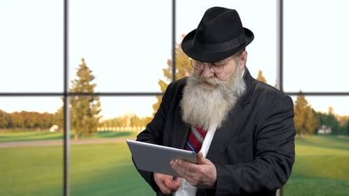 Senior Man Using App on Digital Tablet.