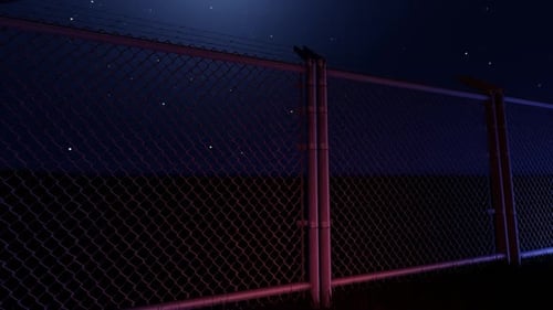 Night Chain Link Fence Tracking Shot with Moody Neon Lighting