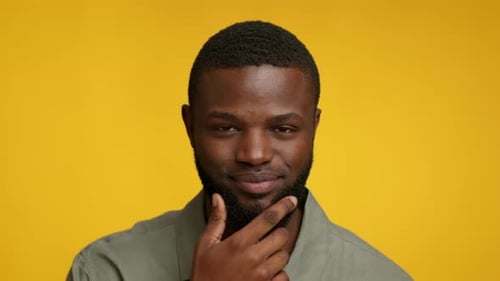 Man Smiles, Puts Finger Up, Got an Idea