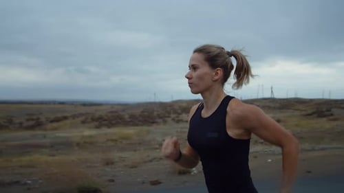 Woman Runs on Rural Road for Fitness
