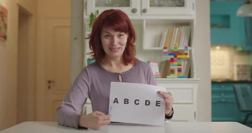 Woman Teaching the Alphabet in Her Home