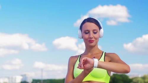 Woman Checking Smartwatch Before Beginning Run Outdoors