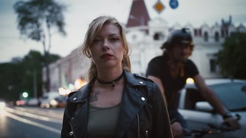 Tattooed Girl Hipster in Leather Jacket and Choker is Standing By Road