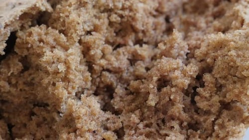 Slow tilt on tasty dark brown bread crust and inside made from full healthy grain and barley 4K 216