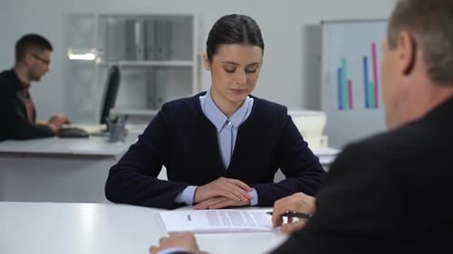 Woman Signs Contract and Shakes Hand in Office