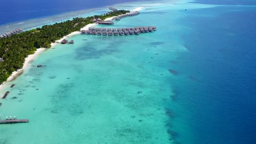 Drone view seascape of shore beach by blue water with sand background
