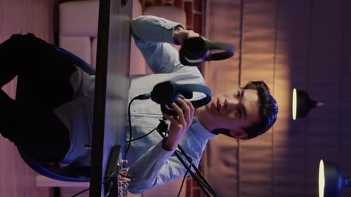 Young Man Prepares to Record Podcast at Desk